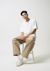 A Chinese man sitting fashion white background