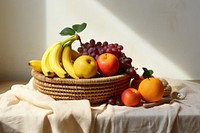 A basket of healthy fruits banana apple table. 