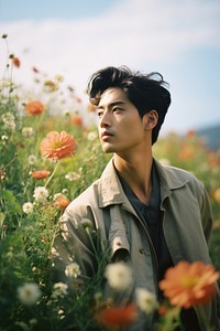 East Asian man flower portrait outdoors. AI generated Image by rawpixel.