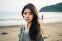 Chinese girl standing near Beach portrait beach photo. AI generated Image by rawpixel.