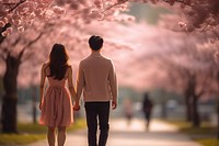 A young couple walking together in the park blossom flower plant. AI generated Image by rawpixel.