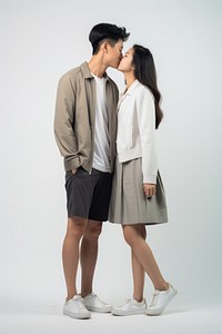 A young asian couple kissing each other shoe standing footwear. AI generated Image by rawpixel.