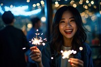 Cheerful hong konger woman sparkler sparks smile. AI generated Image by rawpixel.