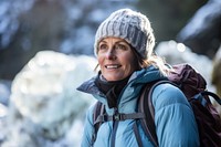 Mature woman on adventure trail in ice backpack outdoors jacket. 