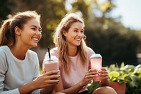 Young female friends in sportswear drinking laughing smile. AI generated Image by rawpixel.