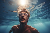Young man swimming underwater glasses recreation. AI generated Image by rawpixel.