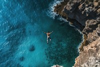 Diving of the cliff in to an ocean sea outdoors nature. AI generated Image by rawpixel.