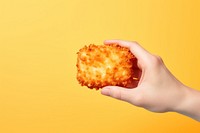 Delicious hash brown holding food hand. AI generated Image by rawpixel.