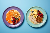 Two plates containing fruit and pancake with nut butter food strawberry breakfast. AI generated Image by rawpixel.