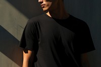An Asain man in a oversize black t shirt portrait t-shirt adult. AI generated Image by rawpixel.