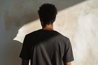 A man in a black t shirt t-shirt shadow sleeve. AI generated Image by rawpixel.