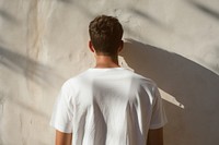 A man in a white t shirt wall architecture t-shirt. AI generated Image by rawpixel.