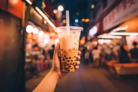 Bubble milk tea holding drink night. 