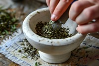 Hand use a white roller to grind herbs medicine spice food. 