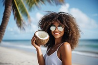 Mexican woman holding a coconut glasses summer beach. 