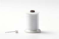 A spool thread with a needle in it white white background technology. AI generated Image by rawpixel.