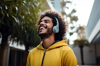 Happy young man headphones listening outdoors. AI generated Image by rawpixel.