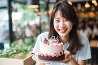 Singaporean woman take a photo of her cake camera party birthday dessert. AI generated Image by rawpixel.