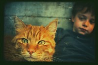 A little boy laying on the floor next to a cat photography portrait mammal. AI generated Image by rawpixel.
