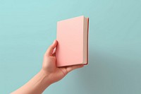 Hand holding book publication diary technology. AI generated Image by rawpixel.