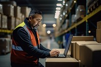 Middle age asian male warehouse worker checking orders at computer workstation laptop adult concentration. AI generated Image by rawpixel.