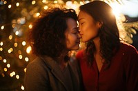 Asian sapphic couple portrait kissing christmas. 