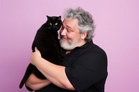 American middle age chubby man hugging black cat pet portrait mammal. 