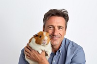 American middle age man hugging guinea pig animal person adult. AI generated Image by rawpixel.