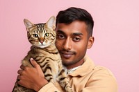 Thai man hugging bengal cat pet portrait animal. AI generated Image by rawpixel.