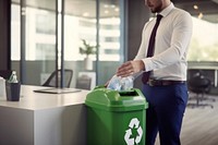 Man in business attire trash bottle into green recycle bin office adult environmentalist. AI generated Image by rawpixel.