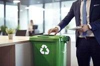 Man in business attire trash bottle into green recycle bin office adult accessories. AI generated Image by rawpixel.