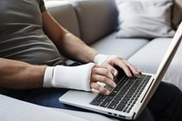 Man with a splint on arm laptop computer adult. AI generated Image by rawpixel.