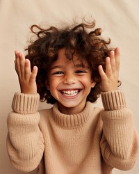 Happy kid in sweater smiling laughing portrait child. AI generated Image by rawpixel.