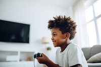 Black kid playing joystick photo happy photography. AI generated Image by rawpixel.