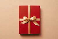 Book with golden ribbon gift red high angle view. AI generated Image by rawpixel.