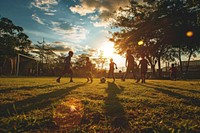 Diverse school kids playing soccer outdoors football nature. AI generated Image by rawpixel.
