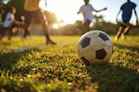 Diverse school kids playing soccer football outdoors sports