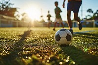 Diverse school kids playing soccer football outdoors sports. AI generated Image by rawpixel.