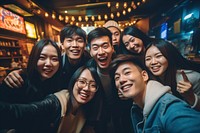 Mixed race asian friends having fun on night out celebration laughing selfie. AI generated Image by rawpixel.