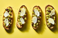Broad bean and pecorino bruschetta yellow food yellow background. AI generated Image by rawpixel.