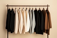 Shirts and sweaters hanging brown rack. 