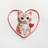 Cat holding heart embroidery textile pattern. 