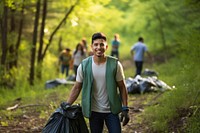 A young Latino environmentalist leading a community cleanup campaign outdoors walking hiking. 