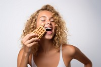 Girl biting eating waffle. 