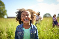 Little African student girl laughing outdoors nature grass. AI generated Image by rawpixel.