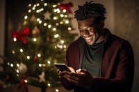 Black man 26 yearsold smilingtexting chat christmas adult anticipation. AI generated Image by rawpixel.