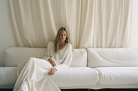 Woman on sofa behind a white curtain sitting contemplation comfortable. AI generated Image by rawpixel.