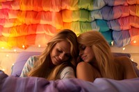 Two girl hug in rainbow bed room blanket adult togetherness. AI generated Image by rawpixel.