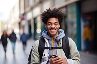 Smiling African student in backpack looking at taplet on street photography adult smile. AI generated Image by rawpixel.