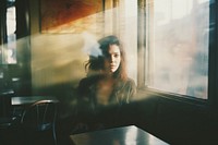 Woman sitting at empty space in cafe adult contemplation architecture. 